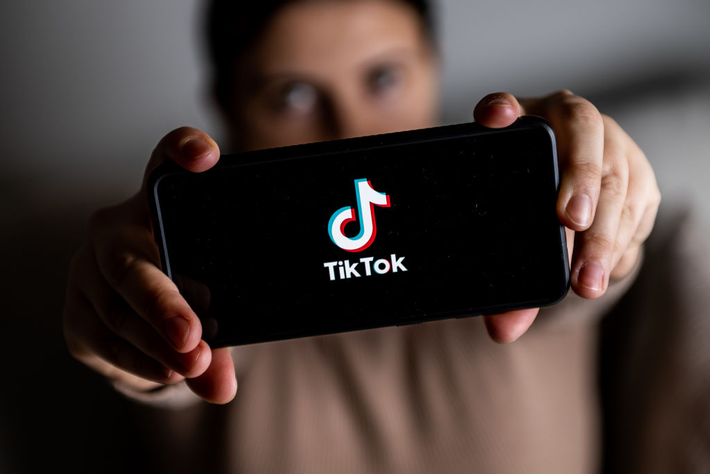 In this photo illustration a TikTok logo seen displayed on a...