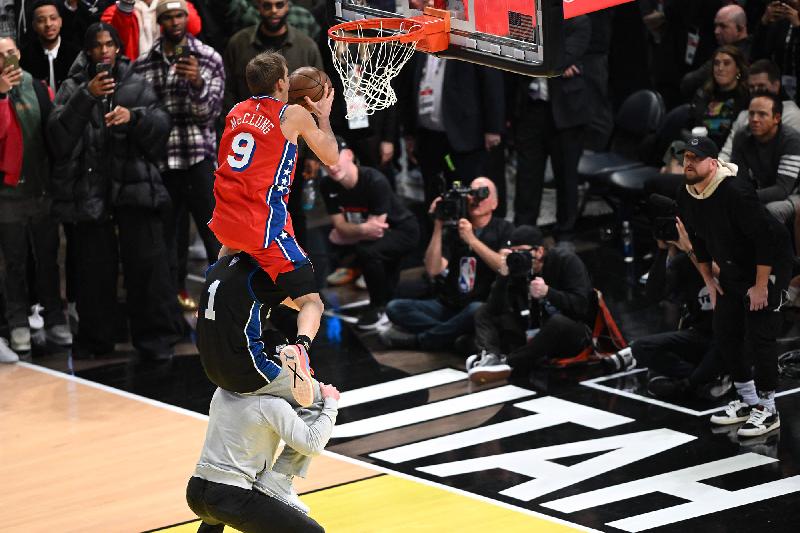 Mac McClung juming over 2 men (Patrick T Fallon-AFP-Getty Images)