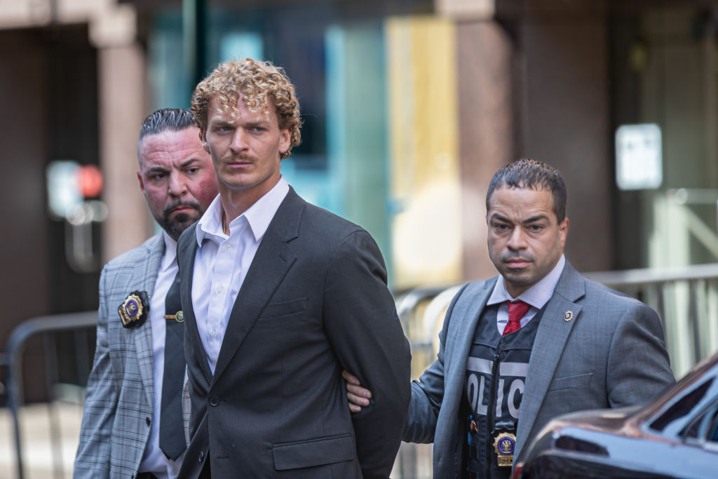 US Marine veteran Daniel Penny, 24, is escorted in handcuffs...