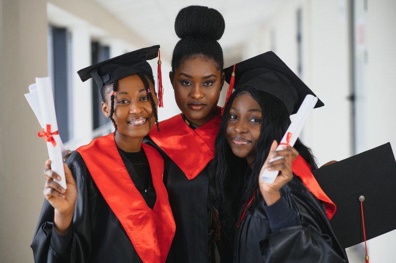 Portrait of multiracial graduates holding diploma