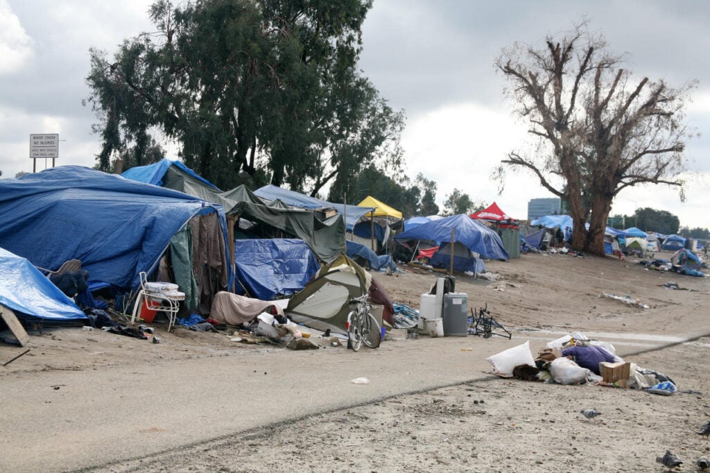 ANAHEIM, CA - JANUARY 9, 2017 Homeless encampment lined up along the Los Angeles River along a bike trail.