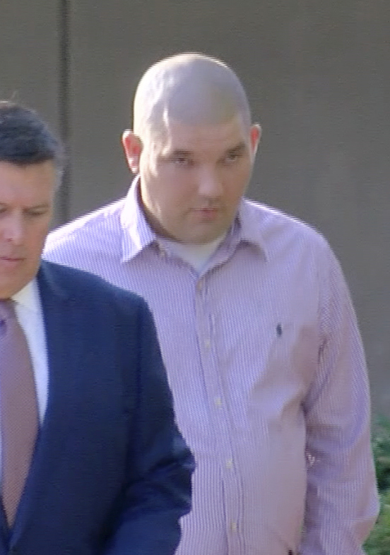 In this image taken from video, Joshua Hartfield, right, a former Richland police officer, walks toward the federal courthouse in Jackson, Miss.