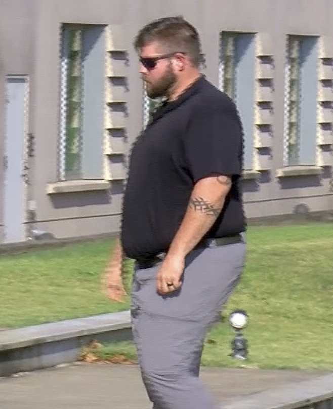 In this image taken from video, Daniel Opdyke, a former sheriff's deputy in Rankin County, Miss., walks into the federal courthouse in Jackson, Miss.