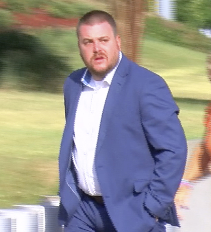 In this image taken from video, Christian Dedmon, a former sheriff's deputy in Rankin County, Miss.,, walks into the federal courthouse in Jackson, Miss.