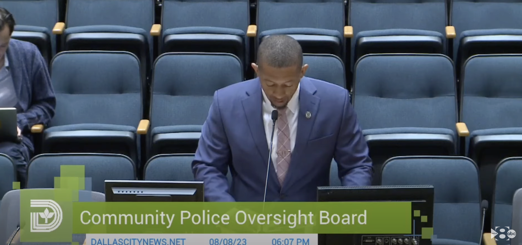 Former Army Sgt. DyNell Lane speaks with his head down at a a Dallas police oversight board meeting