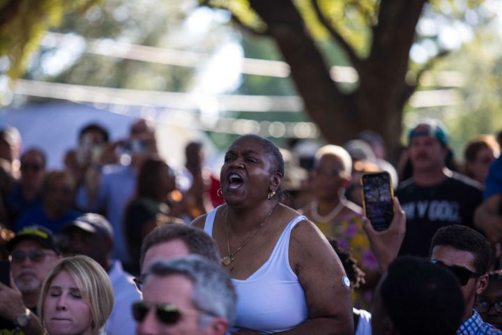 A woman yells as Governor Ron DeSantis is speaking to the crowd.