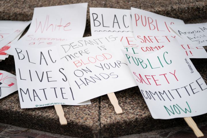 Protest signs on the ground before a rally.