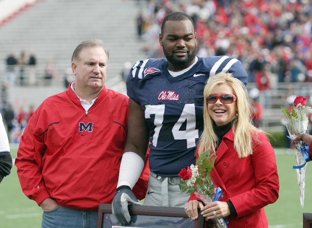 Michael Oher with Sean and Leigh Anne Tuohy (Matthew Sharpe-Getty Images)