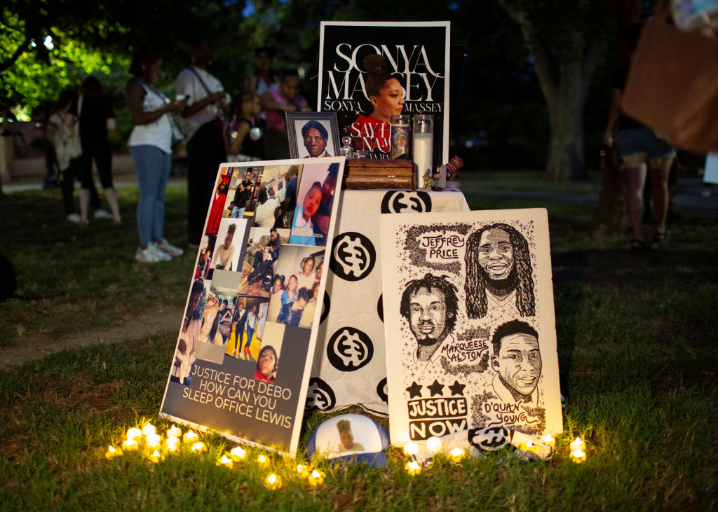 Demonstrators leave signs and candles at Folger Park as they...