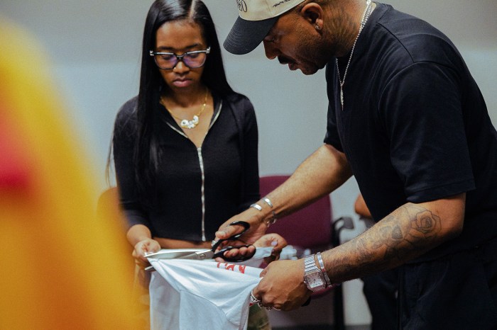 Chase Tupponce helps Dex Robnson cut a shirt during fitting.